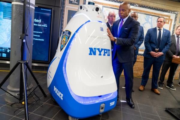Mayor Eric Adams tries to push a 420 pound Knightscope K5 auto<em></em>nomous security robot over during a press co<em></em>nference Friday, September 22, 2023 in Manhattan, New York. (Barry Williams for New York Daily News)