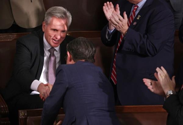 U.S. Rep. Mike Johnson (R-LA) (C) shakes hands with former Speaker of the House Kevin McCarthy (R-CA) (L) after McCarthy voted for him as the House of Representatives holds an election for a new Speaker of the House at the U.S. Capitol on October 25, 2023 in Washington, DC. (Photo by Alex Wong/Getty Images)