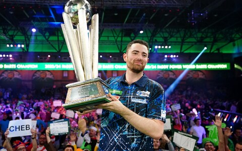 Luke Humphries celebrates with his trophy after beating Luke Littler in the final of the Paddy Power World Darts Championship