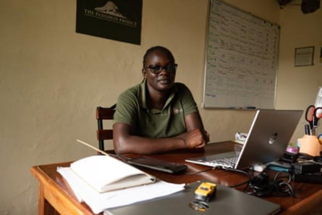A young African woman sitting at a desk