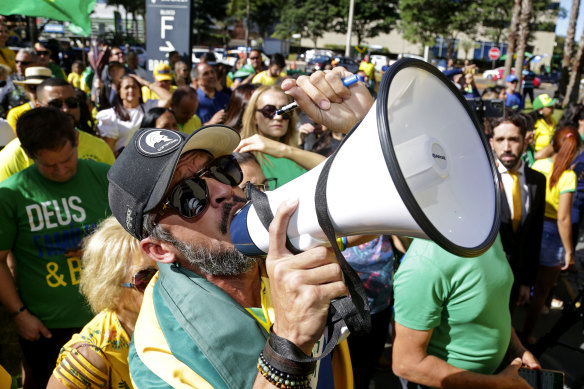Bolso<em></em>naro supporters shout slogans outside the Liberal Party’s headquarters in Brasilia.