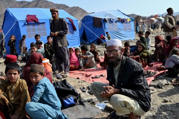 Afghan refugees rest at a makeshift camp upon their arrival from Pakistan, near the Afghanistan-Pakistan Torkham border in Nangarhar province on November 2, 2023. More than 165,000 Afghans have fled Pakistan in the mo<em></em>nth since its government ordered 1.7 million people to leave or face arrest and deportation, officials said on November 2. (Photo by Wakil KOHSAR / AFP) (Photo by WAKIL KOHSAR/AFP via Getty Images)