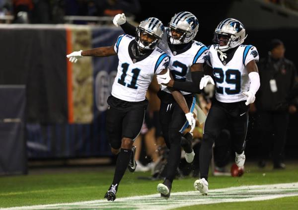 Panthers wide receiver Ihmir Smith-Marsette (11) is co<em></em>ngratulated by his teammates after returning a punt for a touchdown in the first quarter of a game against the Bears at Soldier Field on Nov. 9, 2023.