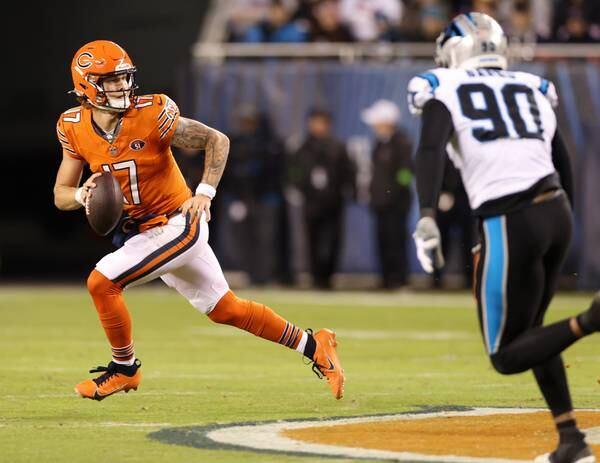 Bears quarterback Tyson Bagent scrambles on a third down as Panthers linebacker Amare Barno pursues in the second quarter at Soldier Field on Nov. 9, 2023.