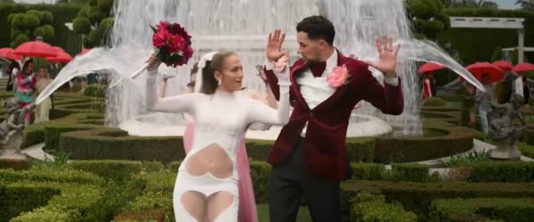 Jennifer Lopez and an actor dancing in front of a fountain in her new film.
