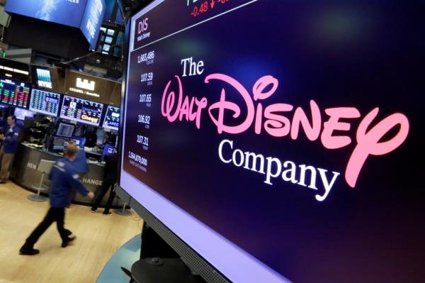 In this Aug. 8, 2017, file photo, The Walt Disney Co. logo appears on a screen above the floor of the New York Stock Exchange.