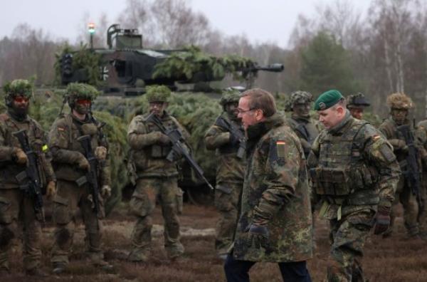 German Defence Minister Boris Pistorius (front L) and Lieutenant co<em></em>lonel, Ralf Georgi, Commander Tank Grenadier Battalion 122, walk past soldiers as Pistorius pays his first visit to troops of the German armed forces Bundeswehr at a military training area in Altengrabow near Moeckern, eastern Germany, on January 26, 2023. (Photo by Ro<em></em>nny Hartmann / AFP) (Photo by Ro<em></em>nNY HARTMANN/AFP via Getty Images)
