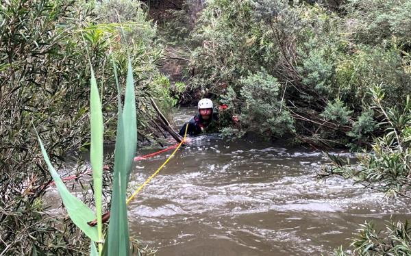 This handout photo taken and released by the Victoria Police on 27 December, 2023 shows an emergency worker during a rescue operation in the midst of flood waters after heavy rain at the Buchan campground in east Gippsland, east of Melbourne in the Australian state of Victoria. Rescue crews were searching for survivors after seven people died in heavy storms across Australia's eastern seaboard, including a 40-year-old woman sucked into a stormwater drain.