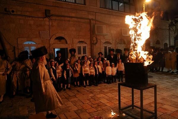 Ultra-Orthodox Jews watch a bo<em></em>nfire built in celebration of the Jewish holiday of Lag B'Omer, in the Mea Shearim neighbourhood of Jerusalem, May 25