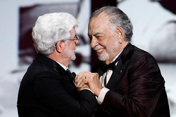 Francis Ford Coppola hugs George Lucas who will receive the Ho<em></em>norary Palme d'Or Award during the closing ceremony of the 77th Cannes Film Festival in Cannes, France, May 25