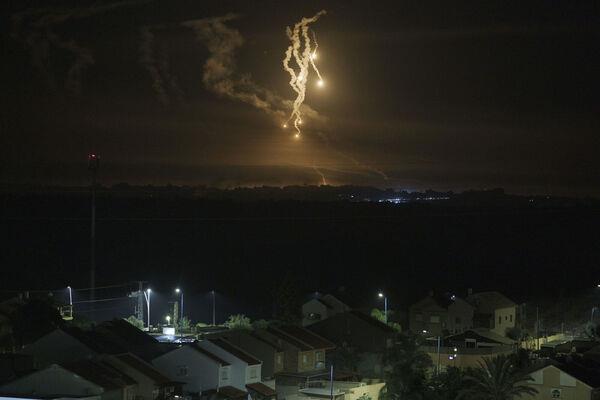 Flares rise over the Gaza Strip, as seen from southern Israel, Wednesday, Nov. 15, 2023. (AP Photo/Leo Correa)
