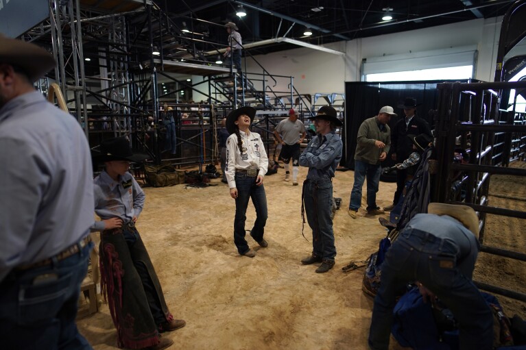 Najiah Knight laughs while waiting to compete in the bull riding competition during the Junior World Finals rodeo, Thursday, Dec. 7, 2023, in Las Vegas. Najiah, a high school junior from small-town Oregon, is on a yearslong quest to become the first woman to compete at the top level of the Professio<em></em>nal Bull Riders tour. (AP Photo/John Locher)