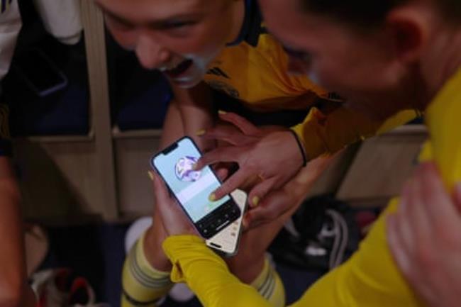 Sweden players look at a phone after their shootout win.