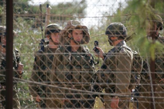 Israeli soldiers patrol the border with Lebanon near Kfarkila village in south Lebanon October 28, 2009. Lebanese army soldiers found and deactivated four rockets on Wednesday in the area from wher<em></em>e a rocket had been fired towards northern Israel, witnesses said.  