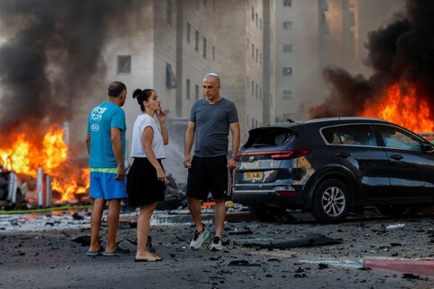 People survey the aftermath after rockets were launched from the Gaza Strip, in Ashkelon, Israel 