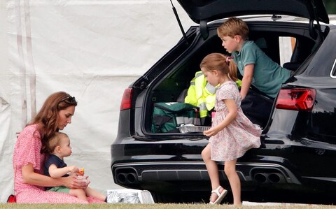 With Princess Charlotte, and Princes Louis and George at the polo in 2019